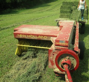 New Holland baler followed by hay wagon